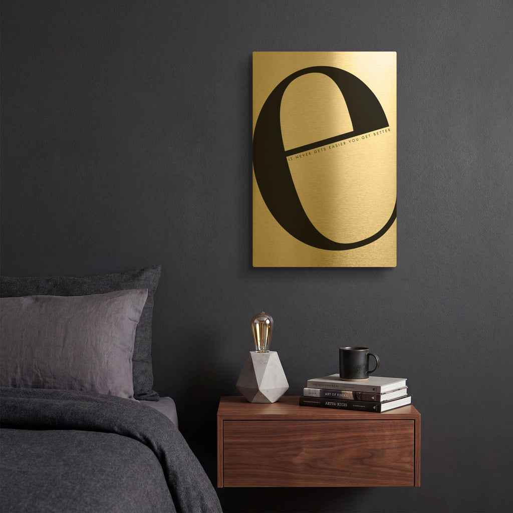 'E is for Easier on White' By Mercedes Lopez Charro Gold Metal Wall Art